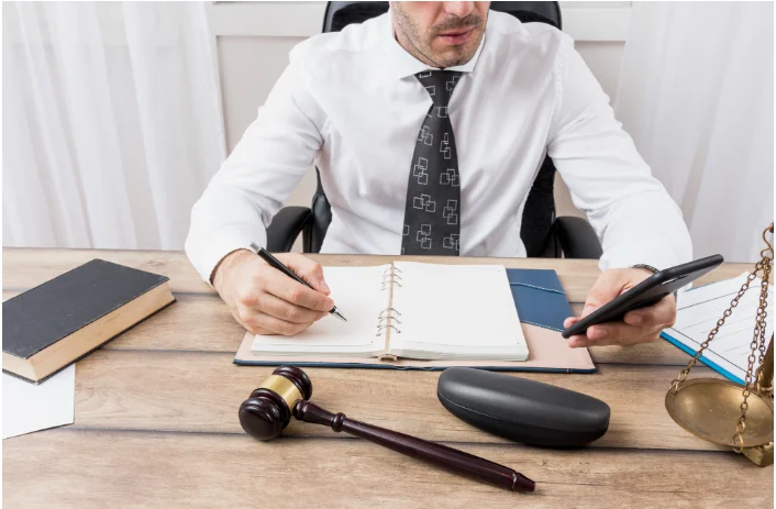 Attorney reviewing financial records and trust account entries for law firm bookkeeping compliance